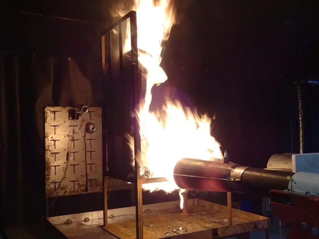 Kerosene burner applying a high-intensity flame during FAA powerplant fire testing.