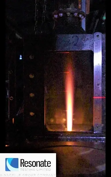 Vertical flammability test apparatus with a controlled burner flame used for material fire testing.