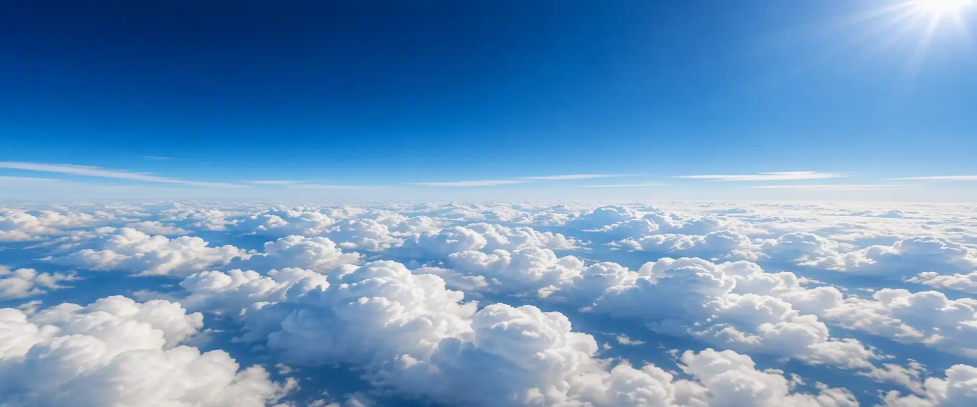 Cloud layer viewed from high altitude, representing reduced-pressure environments encountered during flight.