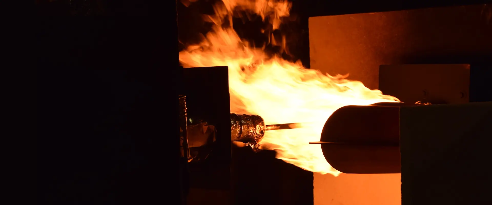 Kerosene burner applying a high-intensity flame during FAA powerplant fire testing.