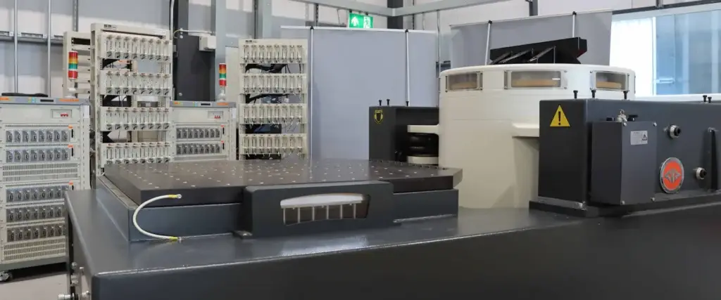 70 kN electrodynamic vibration test system with slip table and battery cycler equipment in a laboratory environment.