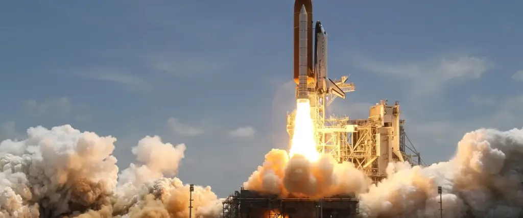 Rocket launch from a launch pad, representing launch environments encountered by space systems and components.